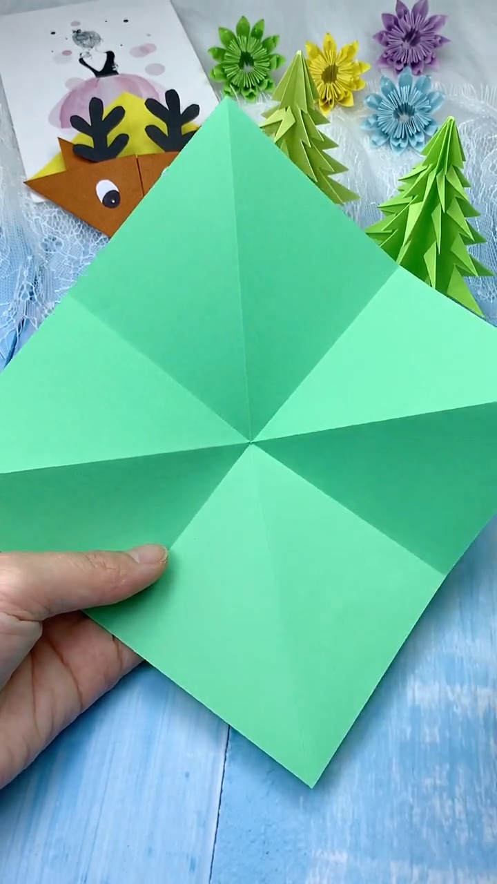 Step 1 Creasing Square Green Origami Paper Along Both Diagonals and Midlines