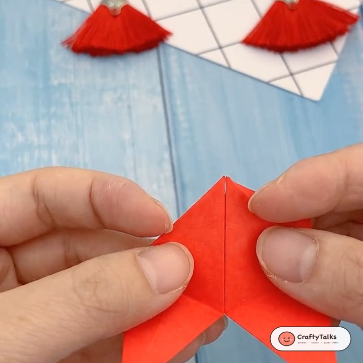 Step 4: Tucking the final remaining flap securely into the slit pocket to lock the folded pentagon