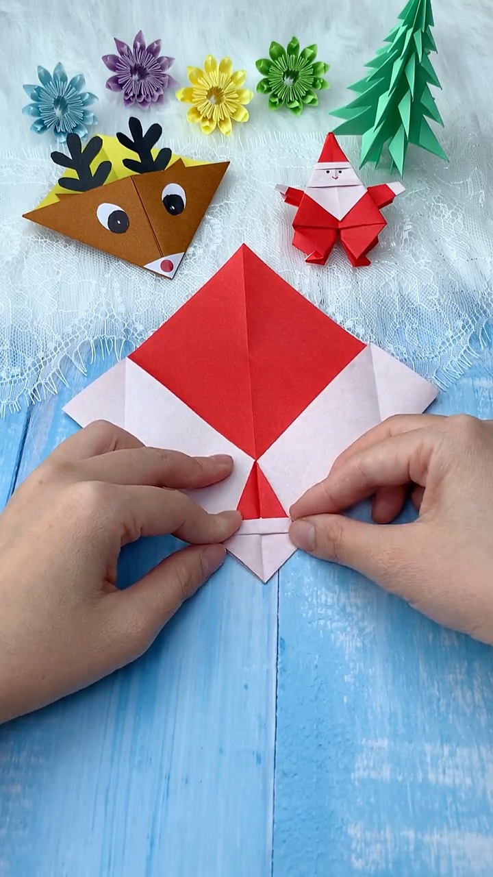 Step 5 Folding Top Flap Downward and Accordion Creasing Santa Face Flap