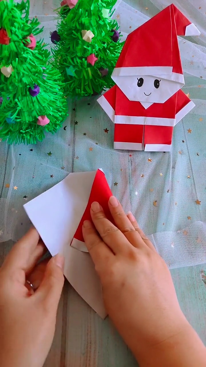 Step 2 Folding Inward into Pointed Kite Shape for Santa Hat